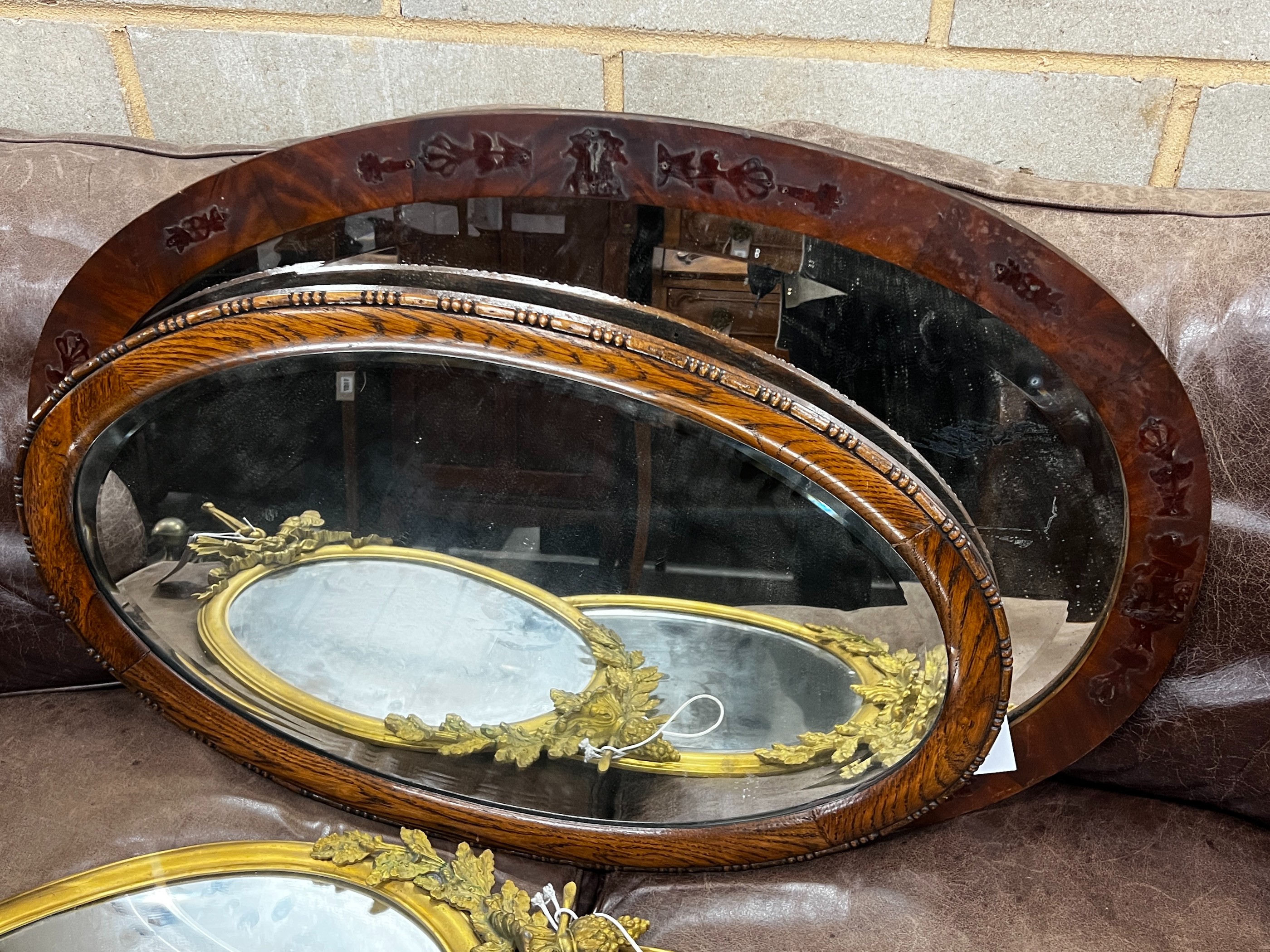 Two early 20th century oval wall mirrors, larger width 86cm